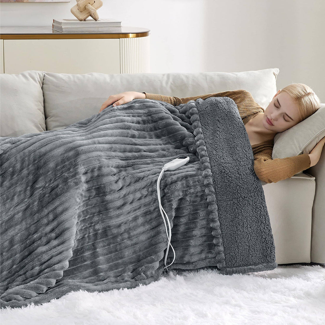 Gray striped flannel heated blanket, folded with sherpa reverse and controller set to 06.