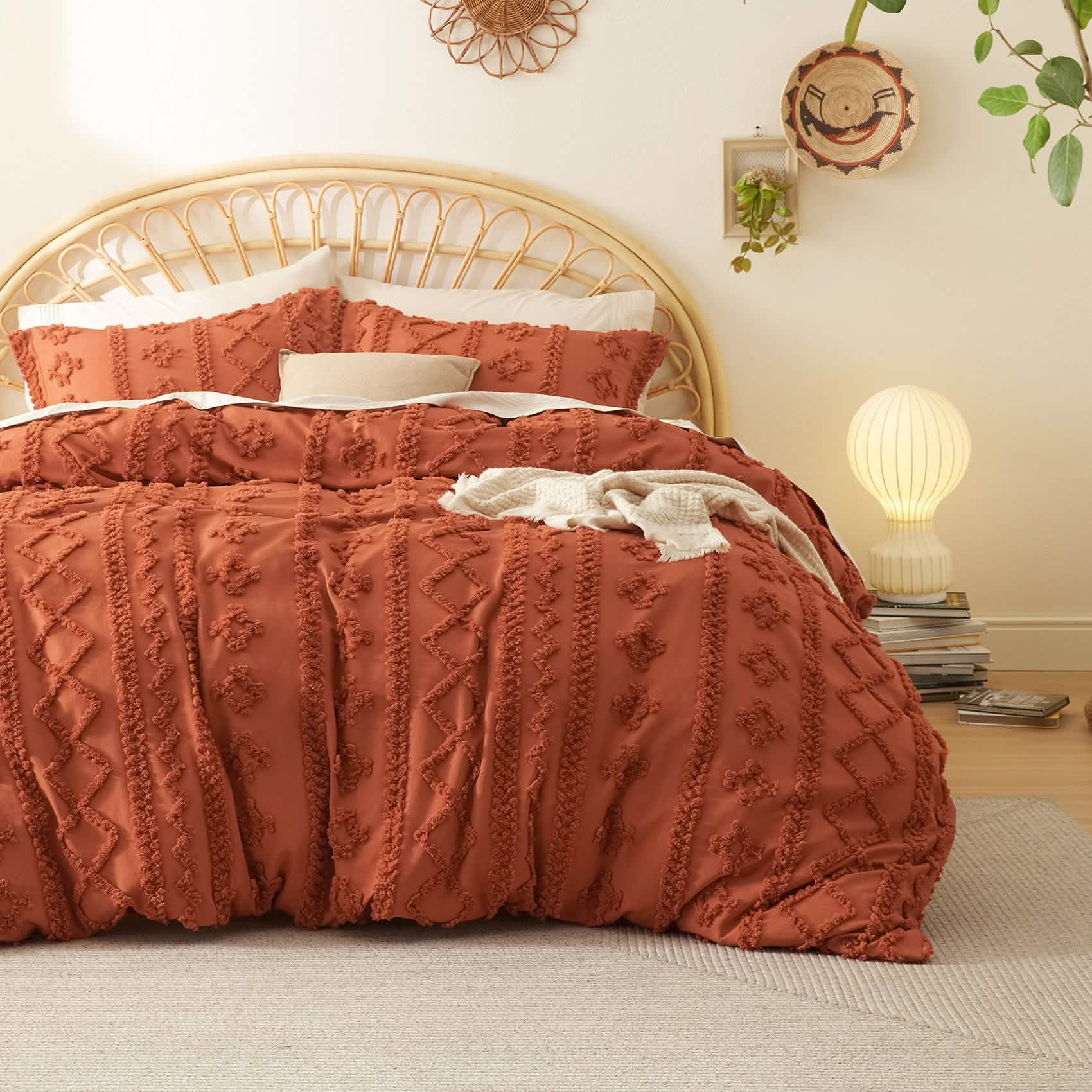 Terracotta boho tufted duvet cover set with geometric embroidery and microfiber texture, on bed with rattan headboard.