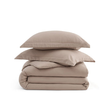 Stack of taupe GentleSoft microfiber duvet cover and pillow shams, showcasing ultra-soft texture.