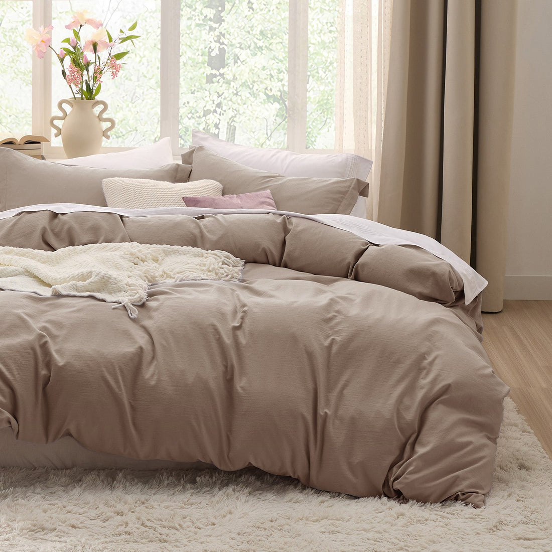 Stack of taupe GentleSoft microfiber duvet cover and pillow shams, showcasing ultra-soft texture.