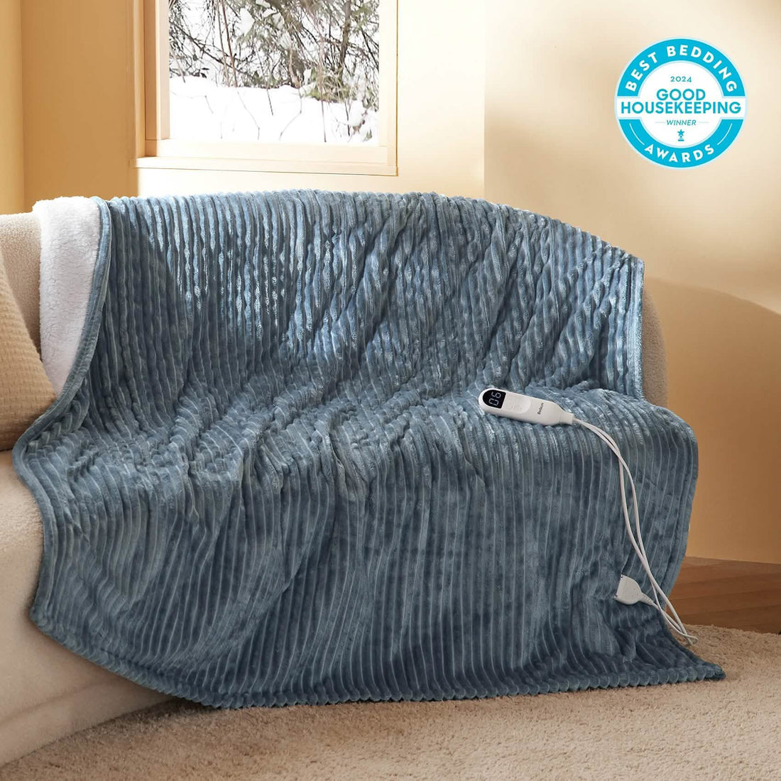 Gray ribbed GentleSoft heated blanket with white sherpa lining and controller displaying heat setting 06.