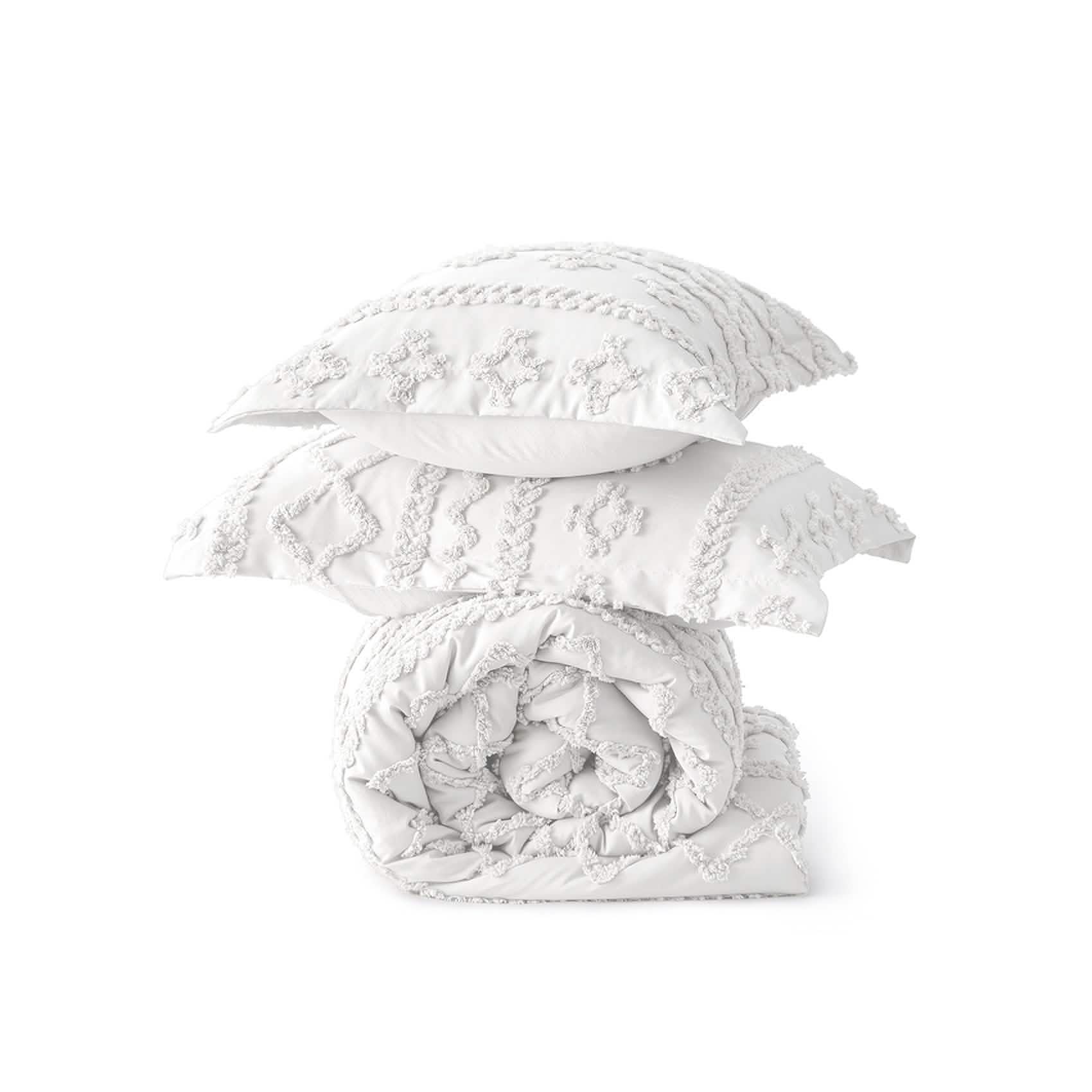 White boho comforter set with diamond and line embroidery, includes rolled comforter and two shams. Soft microfiber texture.