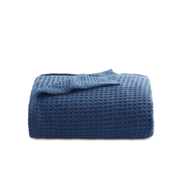 GentleSoft Cotton Waffle Weave Blanket in deep blue, showcasing its soft texture and 3D grid pattern.