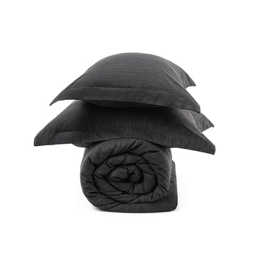 Dark gray GentleSoft comforter set, includes rolled comforter and two pillow shams with dual-tone texture.