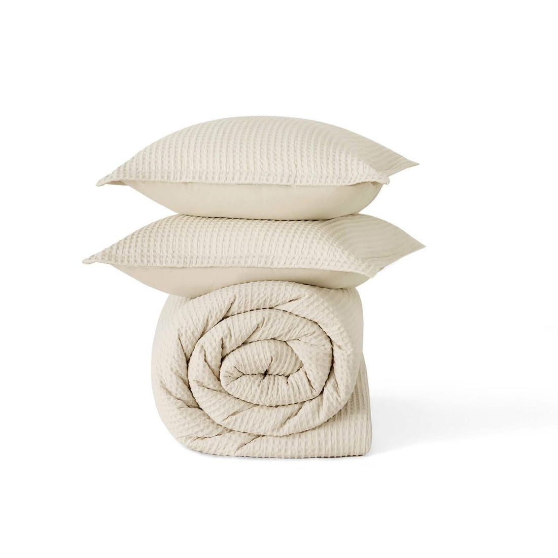 Cream GentleSoft cotton waffle weave comforter and stacked shams, highlighting texture.