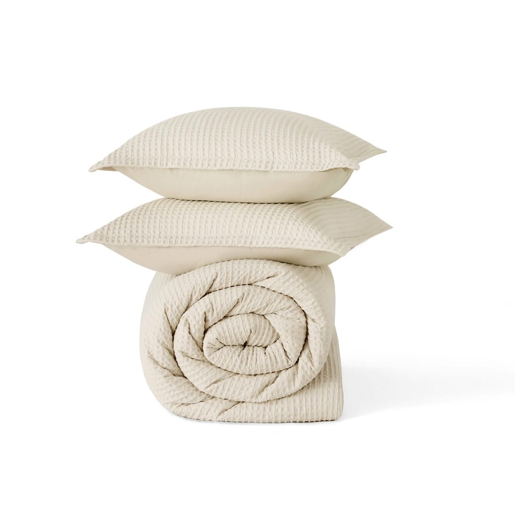 Cream GentleSoft cotton waffle weave comforter and stacked shams, highlighting texture.