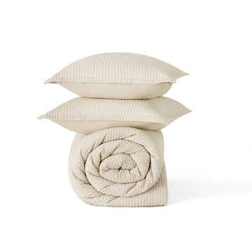 Cream GentleSoft cotton waffle weave comforter and stacked shams, highlighting texture.