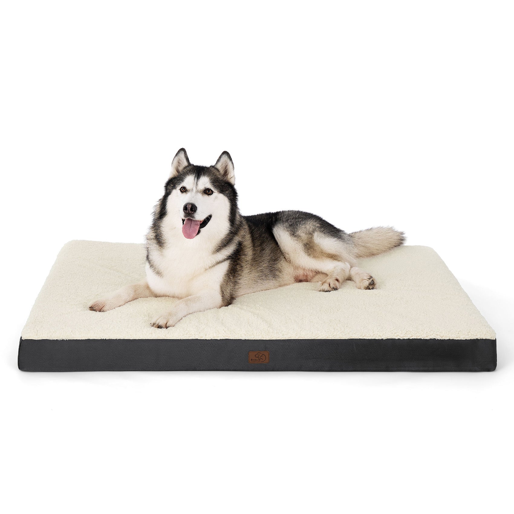 Large Siberian Husky resting on an orthopedic washable dog bed with a cream Sherpa top and dark gray base.