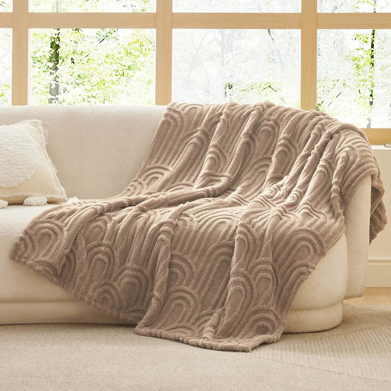 Taupe GentleSoft Arch Shaggy Sherpa Fleece Blanket with raised arch pattern draped on cream sofa, plush texture.