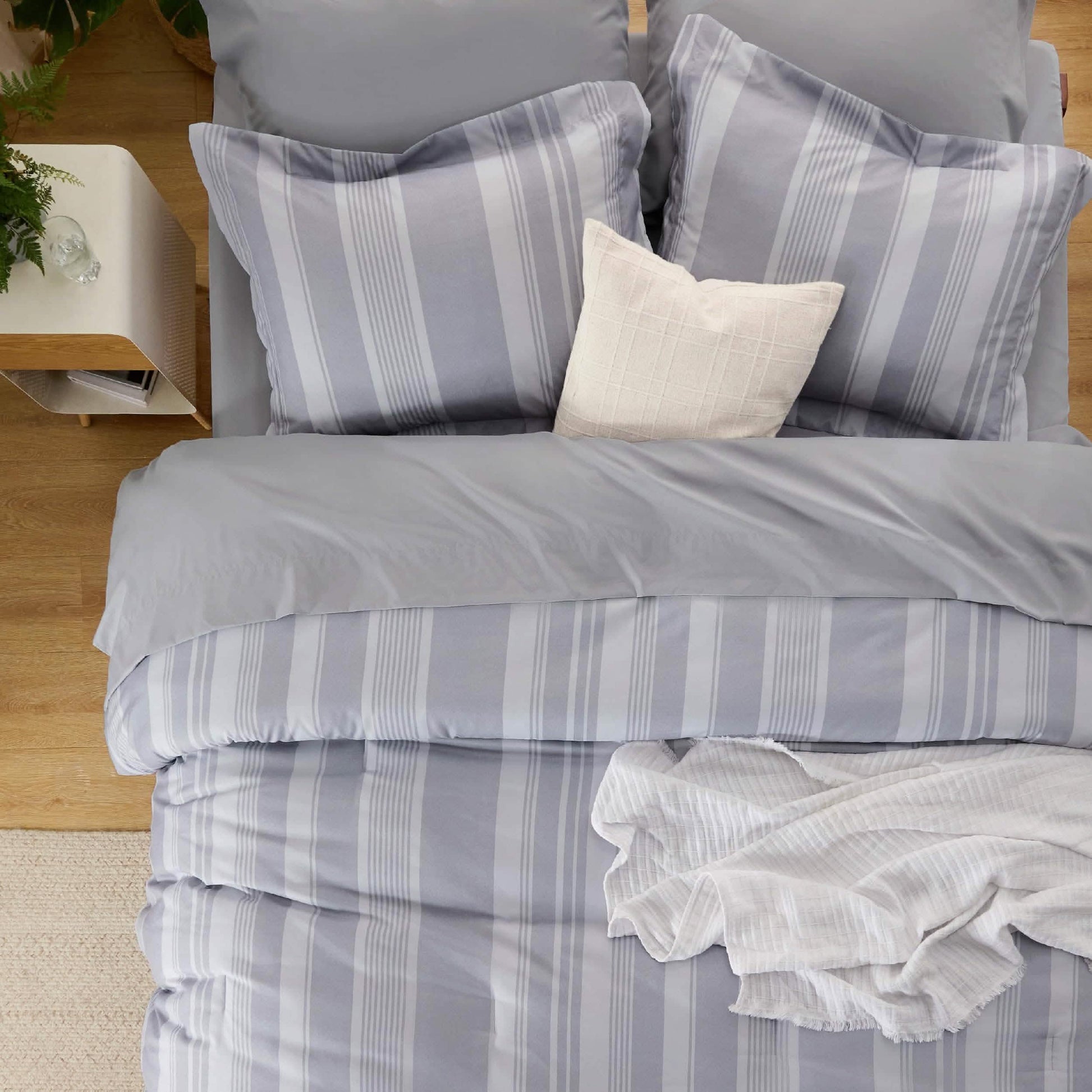 GentleSoft grey and white striped reversible comforter set on a bed.