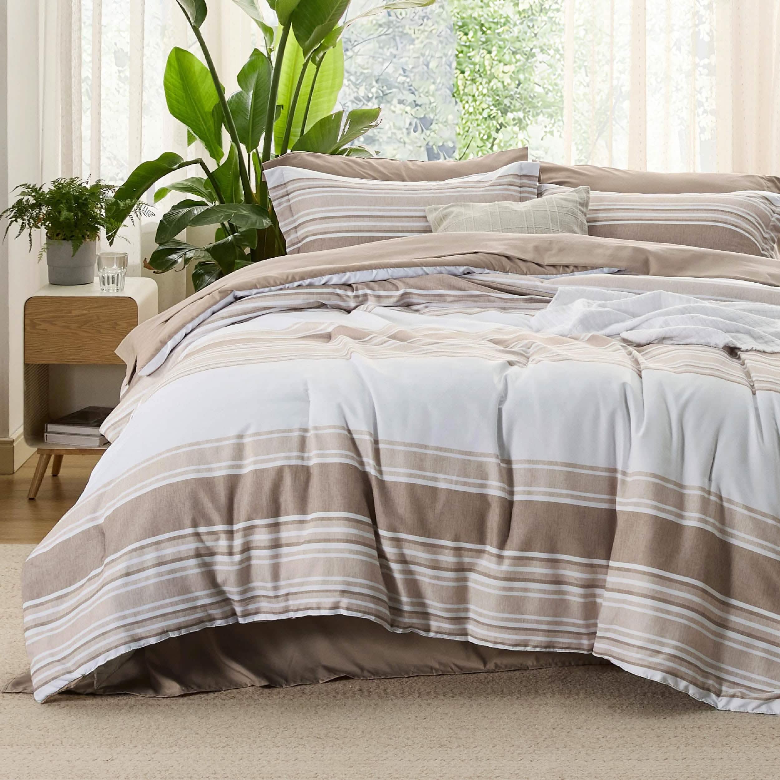 GentleSoft reversible bed-in-a-bag set with white, beige, and light brown horizontal stripes on a made bed.