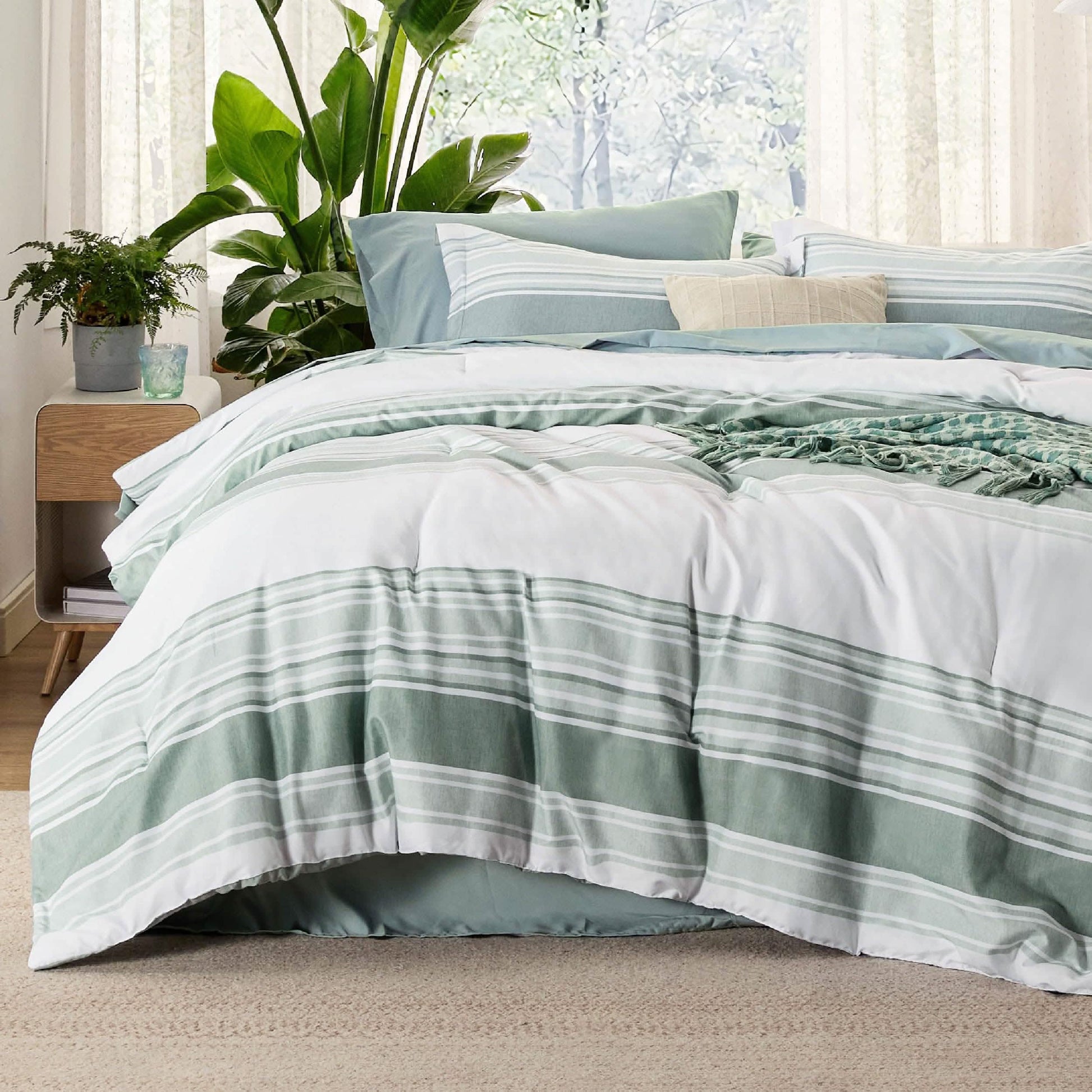 GentleSoft reversible king bed-in-a-bag with sage green and white stripes on a made bed.
