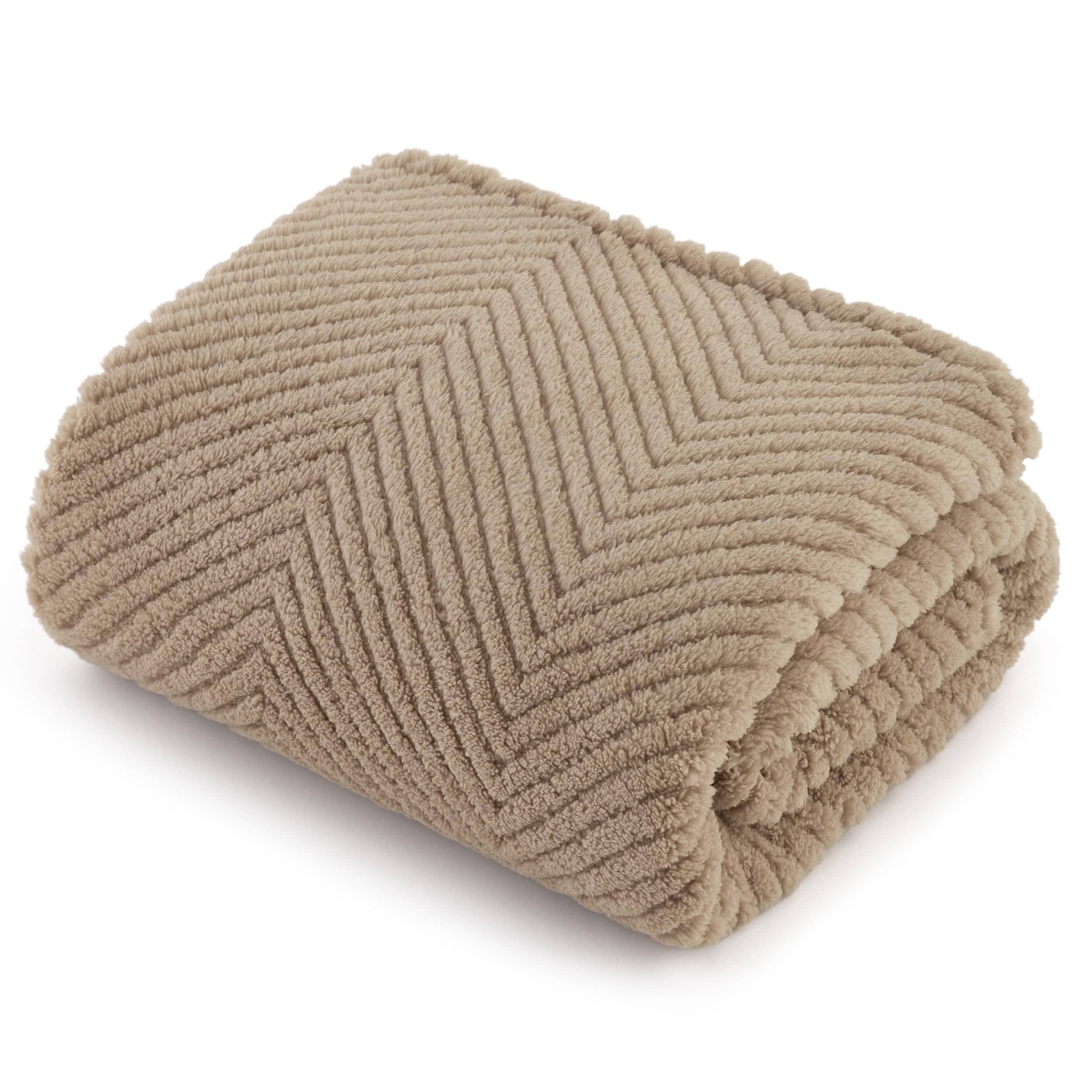 Beige jacquard fleece pet blanket folded, showcasing chevron pattern and soft texture for furniture protection.