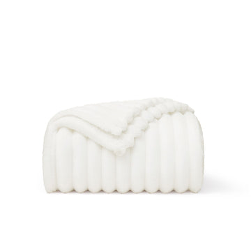GentleSoft white polyester blanket folded, showing ribbed texture and scalloped edge. Cozy, soft, and lint-free.