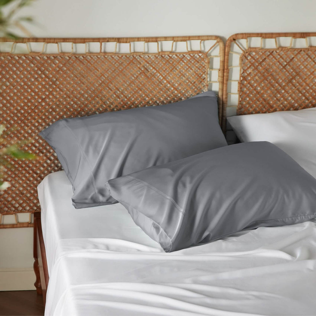 Two charcoal grey GentleSoft rayon derived from bamboo pillowcases with a smooth texture on a bed.
